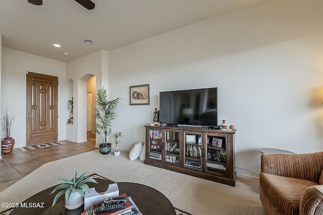 living area with arched walkways, visible vents, recessed lighting, and a ceiling fan