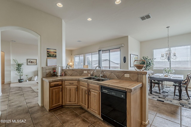 kitchen featuring visible vents, a sink, black dishwasher, tile countertops, and arched walkways