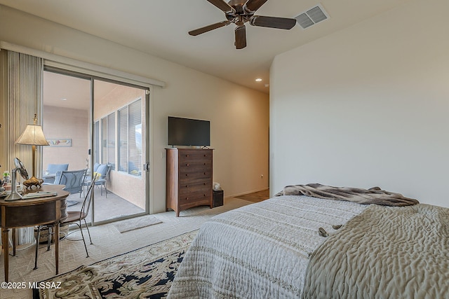 bedroom with access to exterior, visible vents, light colored carpet, and ceiling fan