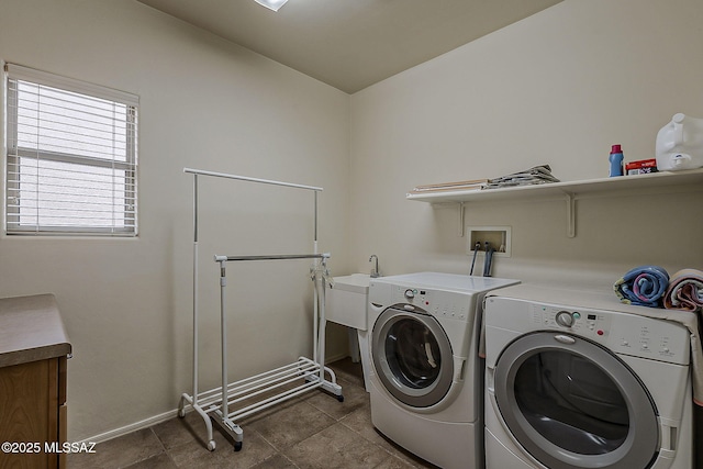 washroom featuring baseboards, separate washer and dryer, and dark tile patterned floors