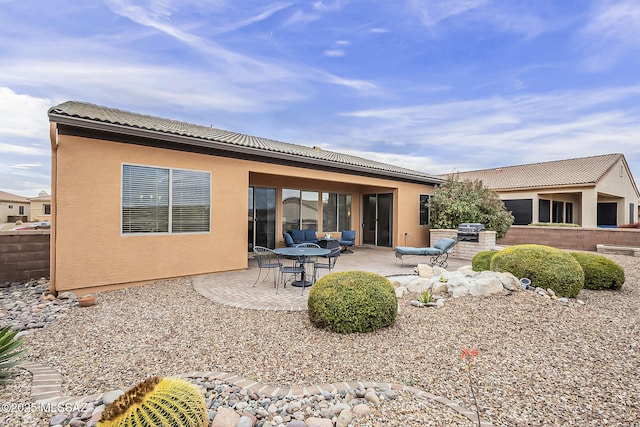 back of property featuring a patio area, stucco siding, and a tiled roof