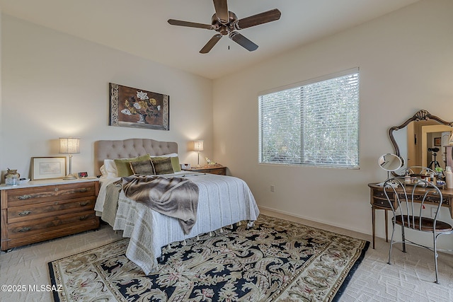 bedroom featuring a ceiling fan and baseboards