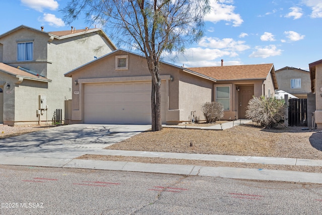 view of front facade featuring concrete driveway, an attached garage, and stucco siding