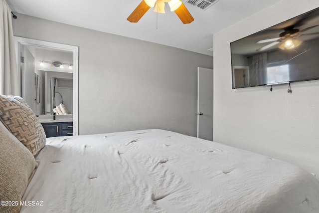 bedroom with visible vents, ensuite bath, and ceiling fan