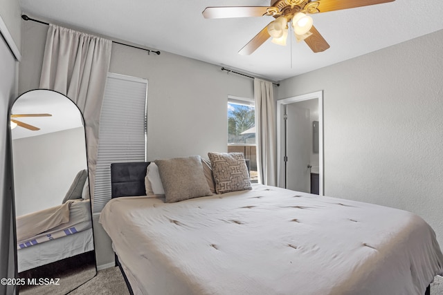 bedroom with a ceiling fan, carpet, and a textured wall