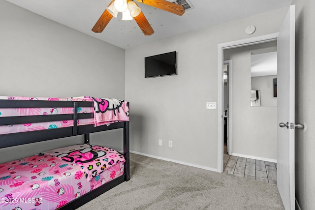 carpeted bedroom featuring baseboards, visible vents, and ceiling fan