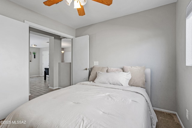 bedroom with a ceiling fan, carpet, and baseboards