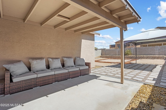 view of patio / terrace featuring a gazebo, an outdoor living space, and a fenced backyard