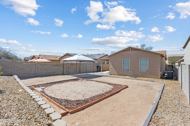 view of yard featuring central air condition unit, a patio area, and a fenced backyard