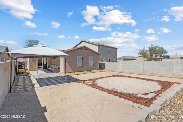 back of house featuring a gazebo, a patio area, and a fenced backyard