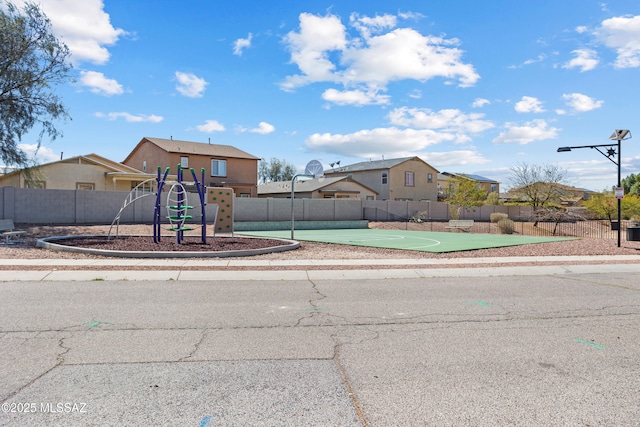 community playground with a residential view and fence