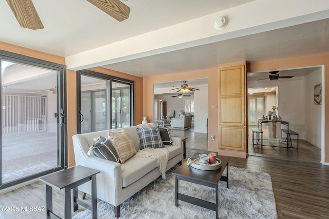 living area featuring wood finished floors and a ceiling fan