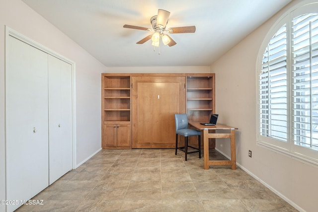 office area with baseboards, a wealth of natural light, and ceiling fan