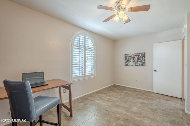 office featuring baseboards and a ceiling fan