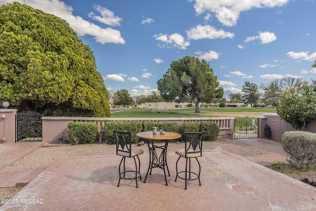 view of patio / terrace featuring fence and a gate