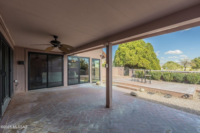 view of patio featuring a ceiling fan and fence