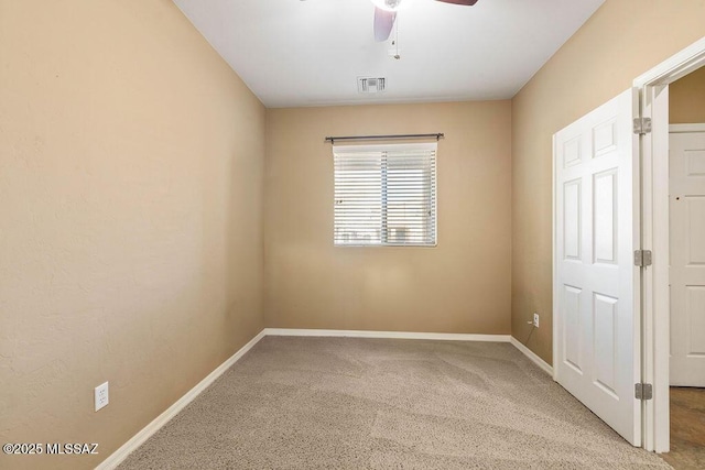 unfurnished bedroom with visible vents, baseboards, carpet, and a ceiling fan