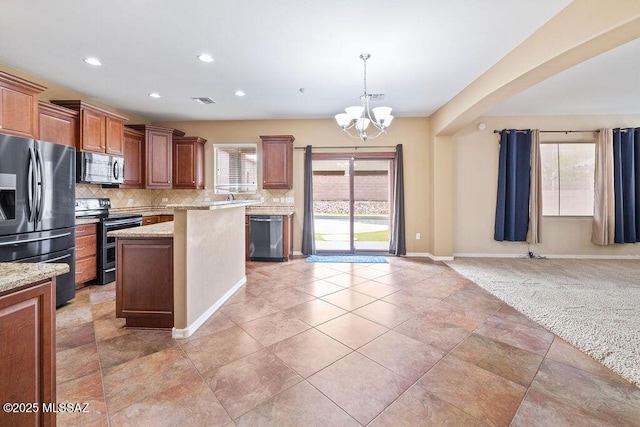 kitchen featuring tasteful backsplash, a center island, stainless steel appliances, an inviting chandelier, and light colored carpet