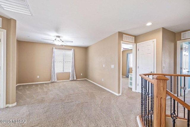 unfurnished room with visible vents, baseboards, and ceiling fan