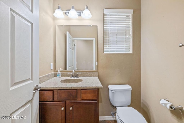 bathroom with toilet and vanity