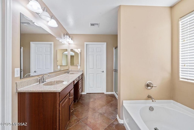 bathroom with visible vents, double vanity, a stall shower, a bath, and a sink