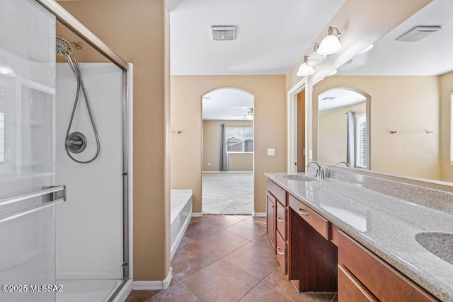 full bathroom featuring a shower stall, double vanity, visible vents, and a sink