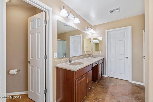 bathroom with visible vents, baseboards, and a sink