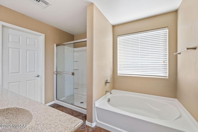 full bath featuring a garden tub, visible vents, tile patterned floors, and a stall shower