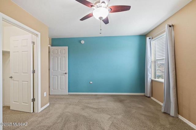 unfurnished bedroom with a ceiling fan, baseboards, and carpet floors