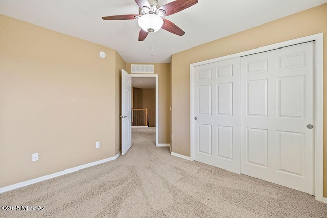 unfurnished bedroom with visible vents, a ceiling fan, a closet, carpet floors, and baseboards