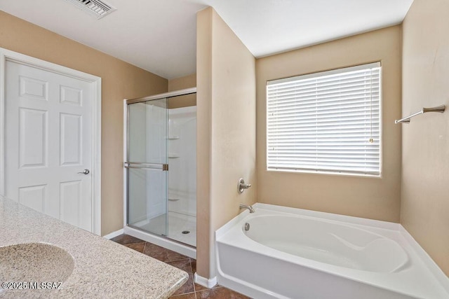 full bathroom with a shower stall, tile patterned floors, a garden tub, and visible vents