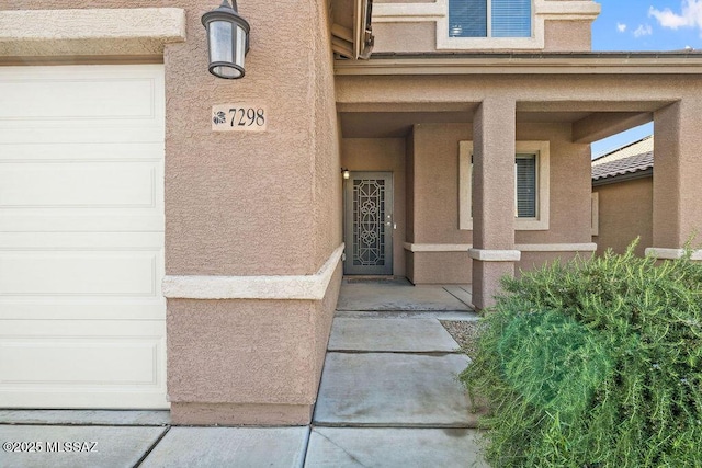 entrance to property featuring stucco siding