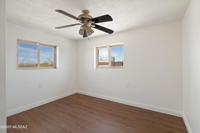 spare room featuring ceiling fan, a textured ceiling, baseboards, and wood finished floors