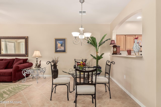 dining area with visible vents, baseboards, light tile patterned flooring, and a chandelier