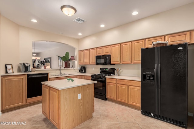 kitchen featuring visible vents, light countertops, light tile patterned floors, black appliances, and a sink