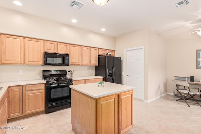 kitchen featuring visible vents, black appliances, light tile patterned flooring, and light brown cabinets