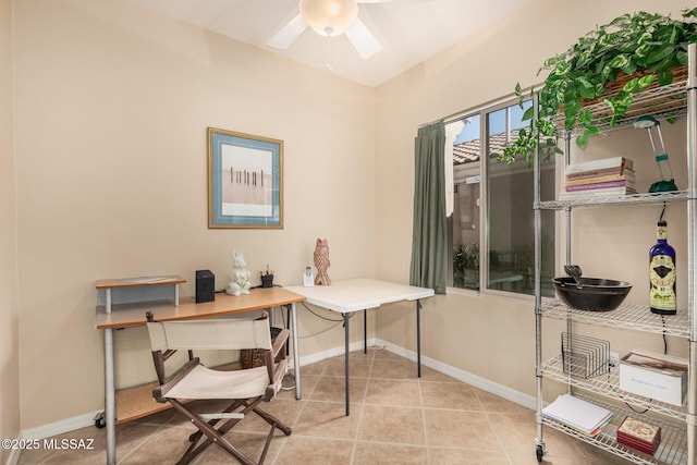 tiled home office featuring baseboards and a ceiling fan