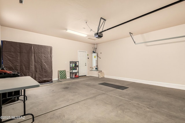 garage featuring gas water heater, a garage door opener, and baseboards