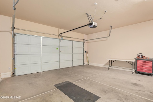 garage with a garage door opener and baseboards