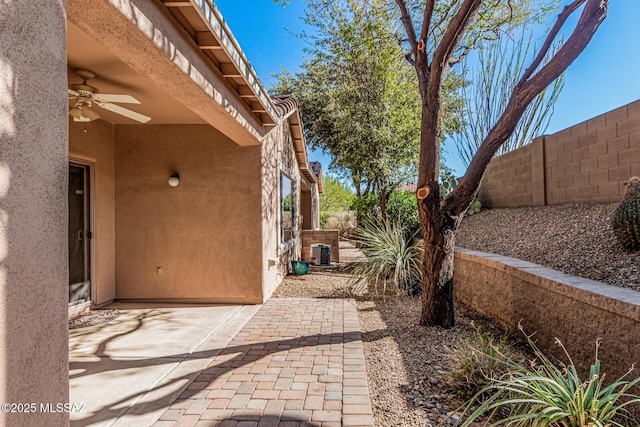 view of patio / terrace featuring a fenced backyard, central AC, and ceiling fan