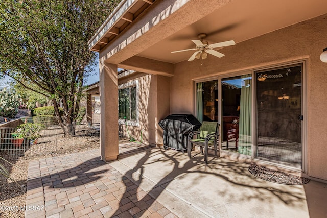 view of patio with fence and ceiling fan