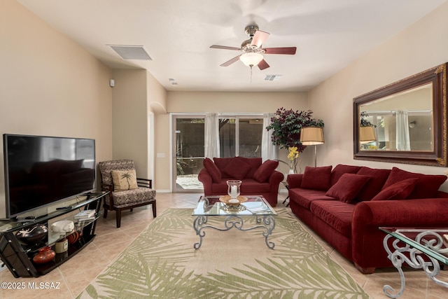 living room with light tile patterned floors, a ceiling fan, and visible vents