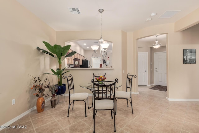 dining area featuring light tile patterned floors, visible vents, baseboards, and an inviting chandelier