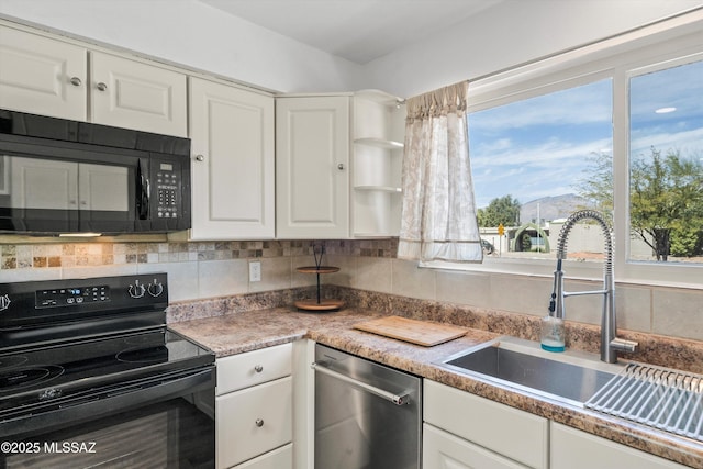 kitchen featuring black appliances, white cabinets, tasteful backsplash, and a sink