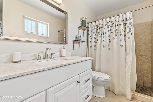 bathroom featuring a tile shower, tile patterned flooring, toilet, and vanity