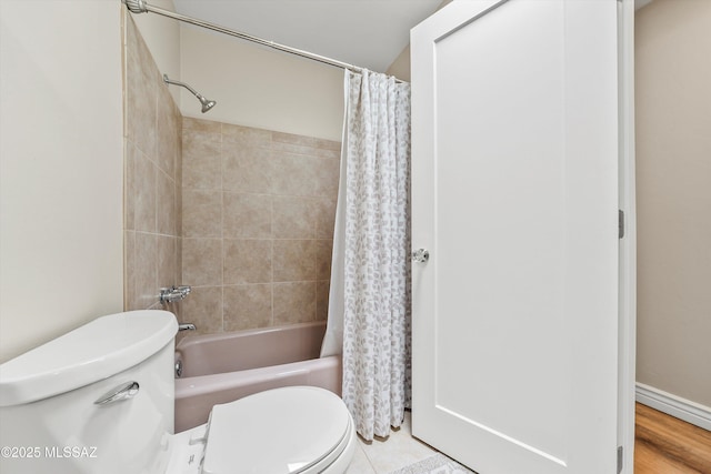 bathroom with shower / tub combo and toilet