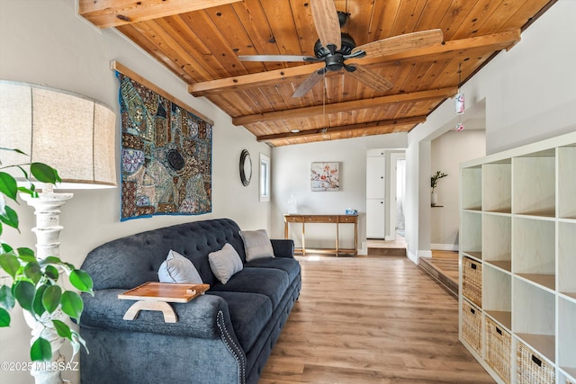 living room with beam ceiling, a ceiling fan, wood finished floors, wooden ceiling, and baseboards