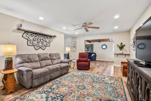 living area with recessed lighting, baseboards, and wood finished floors