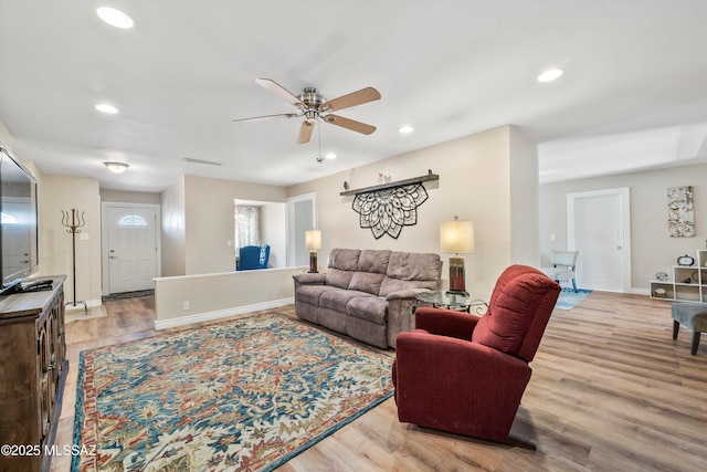 living area with recessed lighting, baseboards, light wood-style floors, and ceiling fan