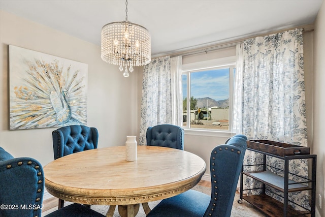 dining space featuring a notable chandelier, wood finished floors, and baseboards